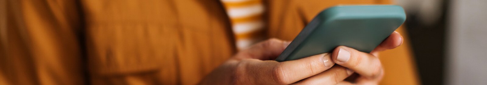 Close up of a person's hands holding a smartphone