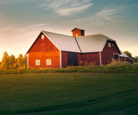 A classic red barn in a field