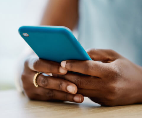 Close up of a person's hands holding a smartphone